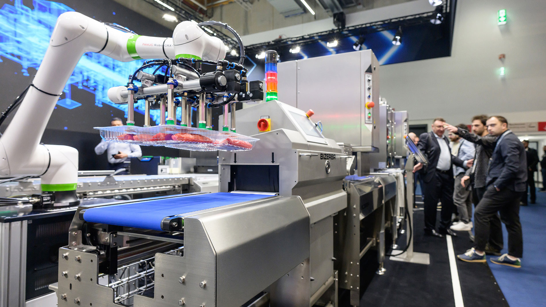 Robotic arm handling packaged goods on an automated conveyor lin