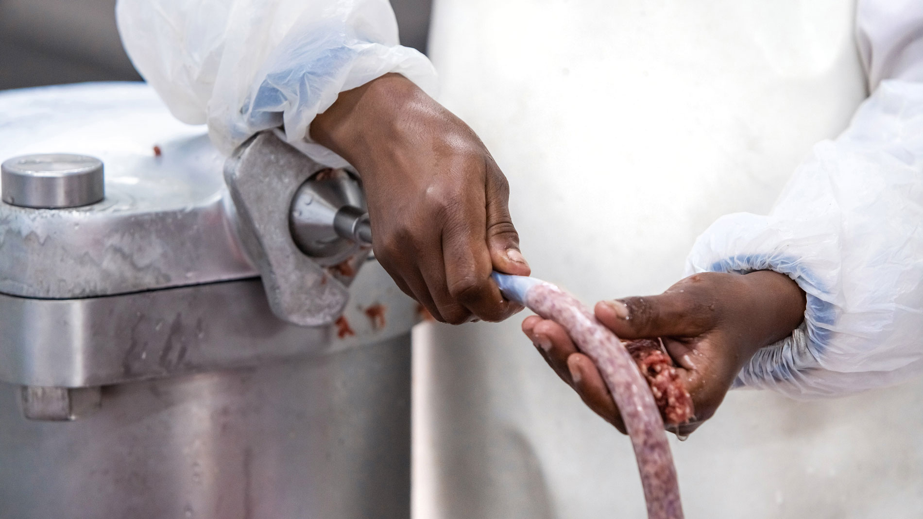 Close-up of sausage casing being filled