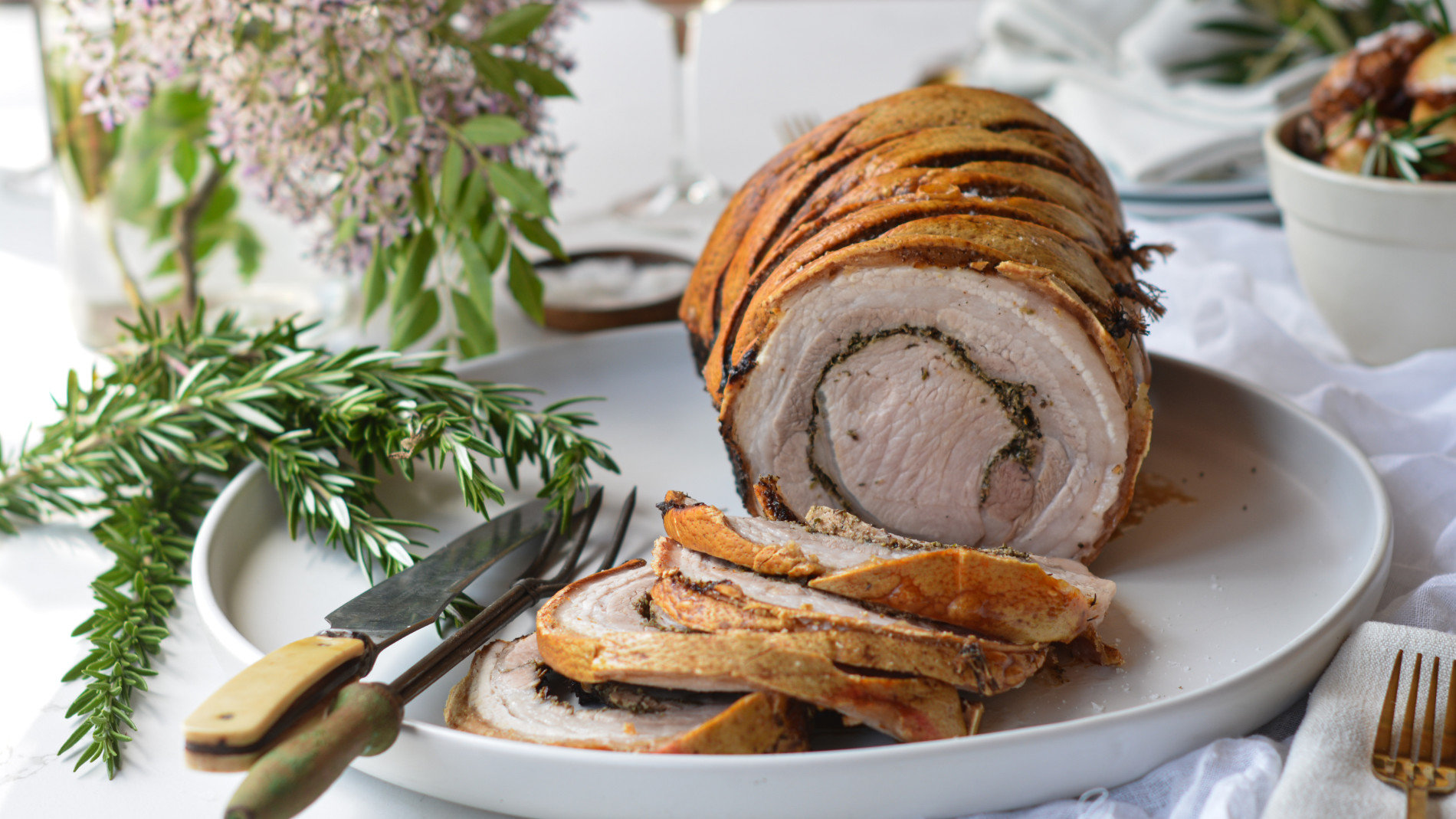 Sliced roast pork on a festively laid table
