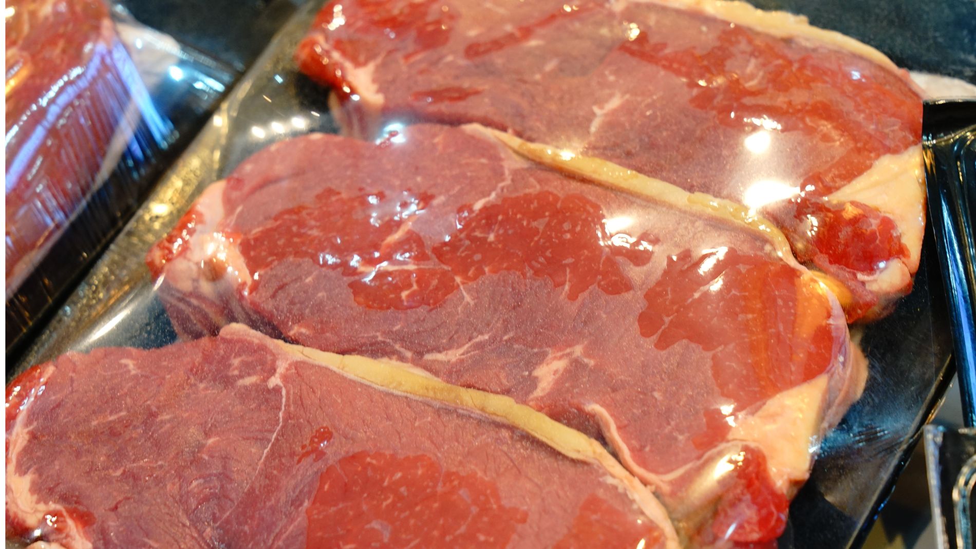 Fresh steaks packaged and displayed in meat counter